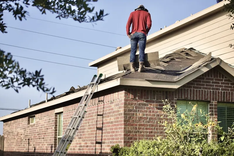 Professional roofer working on a residential roof in Baldwin Harbor